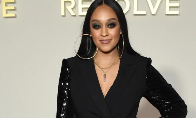 Tia Mowry Slips Into Sleek Thigh-High Boots & Denim Minidress