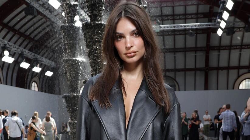 Emily Ratajkowski Channels ’90s Minimalism in Leather Trench and Boots at Loewe’s Spring 2024 Men’s Show