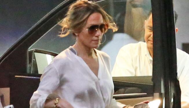 Jennifer Lopez Soars in 6-Inch Clear Heels and White Blouse & Matching Pants in Los Angeles