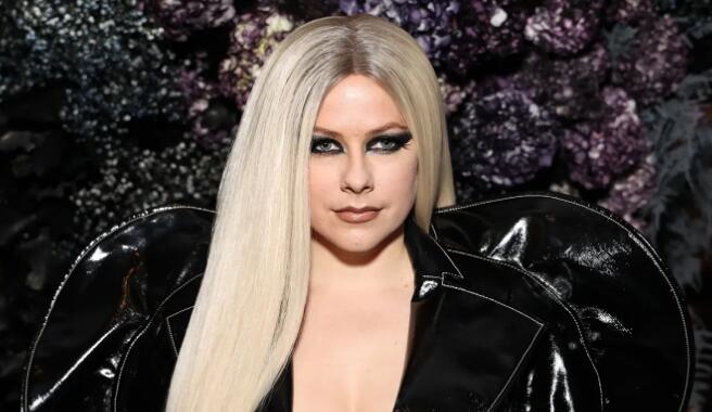 Avril Lavigne Turns Heads in Grungy Combat Boots and Sculptural Trench Coat at Christian Siriano’s NYFW Show