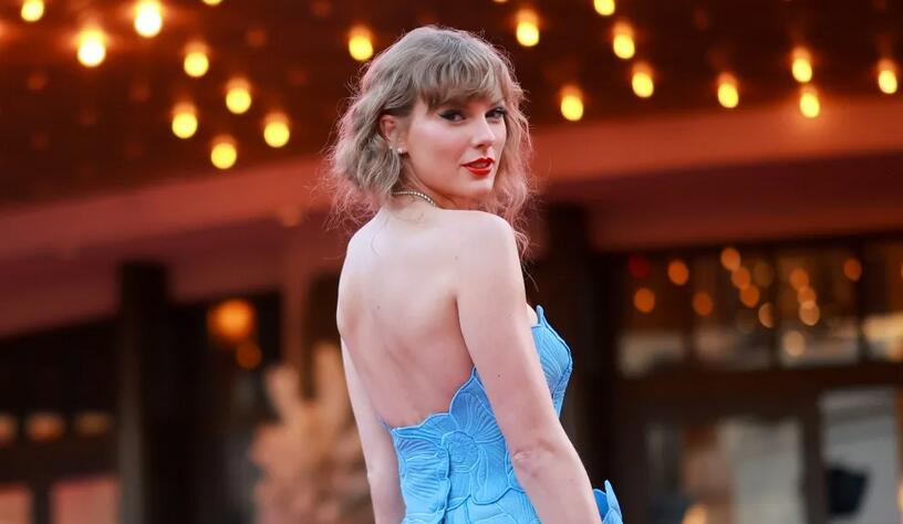 Taylor Swift Blooms at ‘Eras Tour’ Movie Premiere in Blue Floral Gown and Matching Strappy Sandals