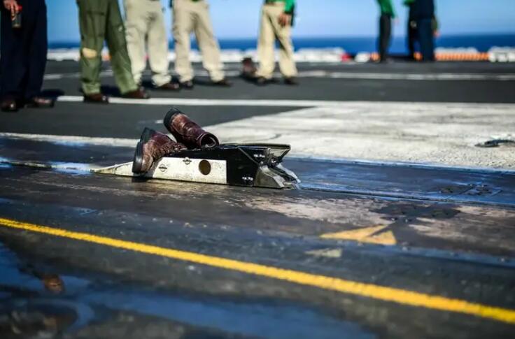 Here’s why it’s an aircraft carrier tradition to catapult a pair of boots